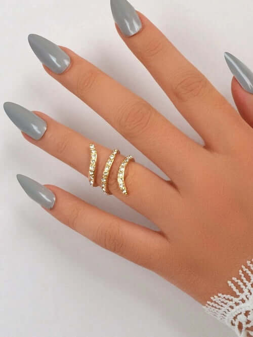 Bridal Jewelry Full Rhinestone Engagement Ring showcased on a hand with long gray nails, adorned with sparkling rhinestones.