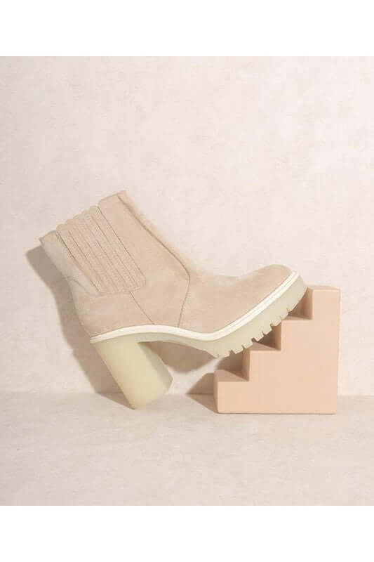 ANASTASIA- PANELED BOOTS FOR WOMEN'S displayed on a beige pedestal, showcasing stylish design and durable material.