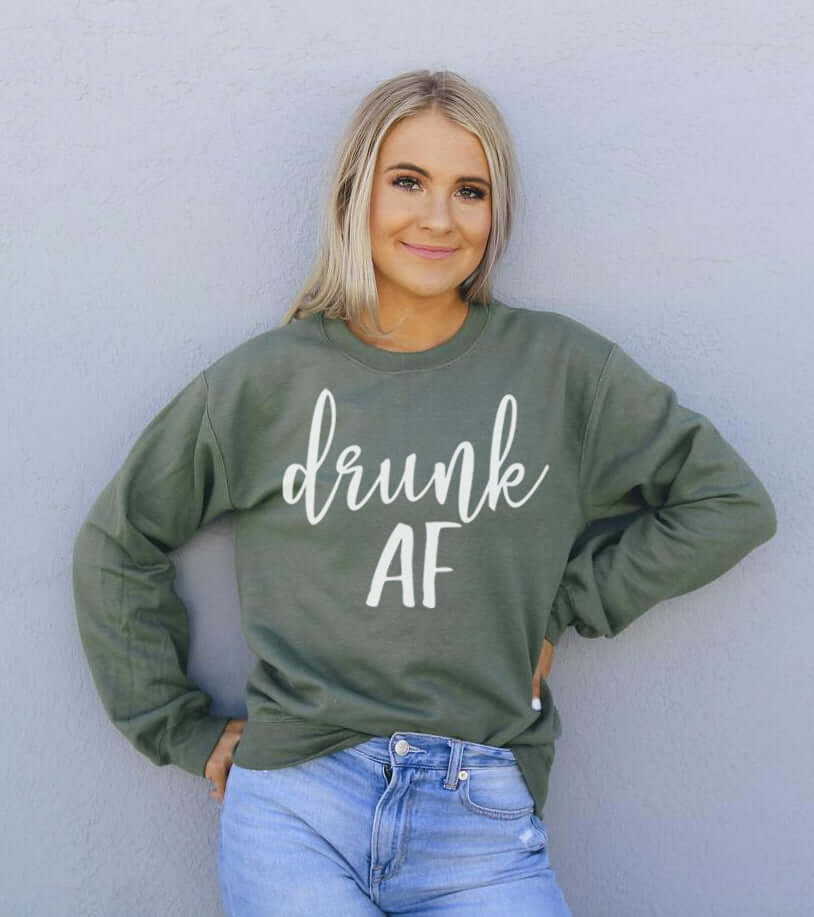 Model wearing a green Drunk AF Sweatshirt, featuring a crew neck and casual style.