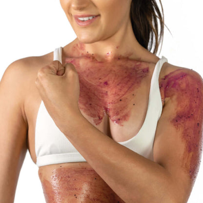 Woman applying Ultra-Nourishing Exfoliating Mask with mixed berries on skin for anti-aging benefits.