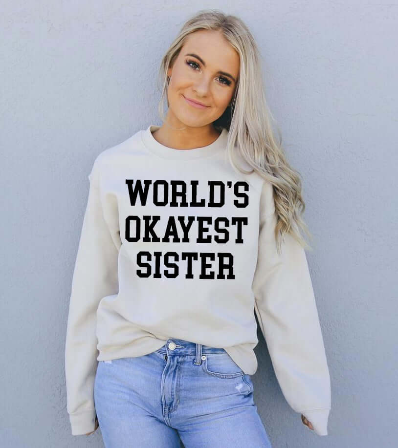 Model wearing the World's Okayest Sister Sweatshirt showcasing its comfortable fit and design.