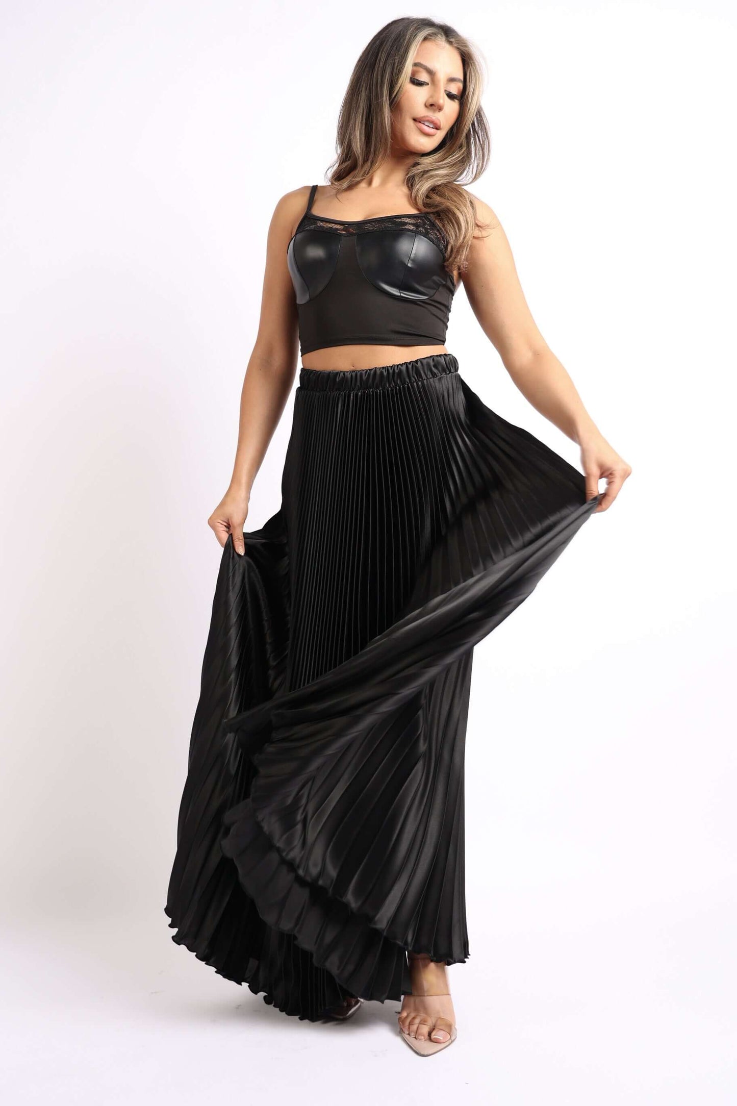Elastic High Waist A-Line Pleated Satin Maxi Skirt Formal Prom BLACK modeled by a woman in a stylish top and flowing skirt.