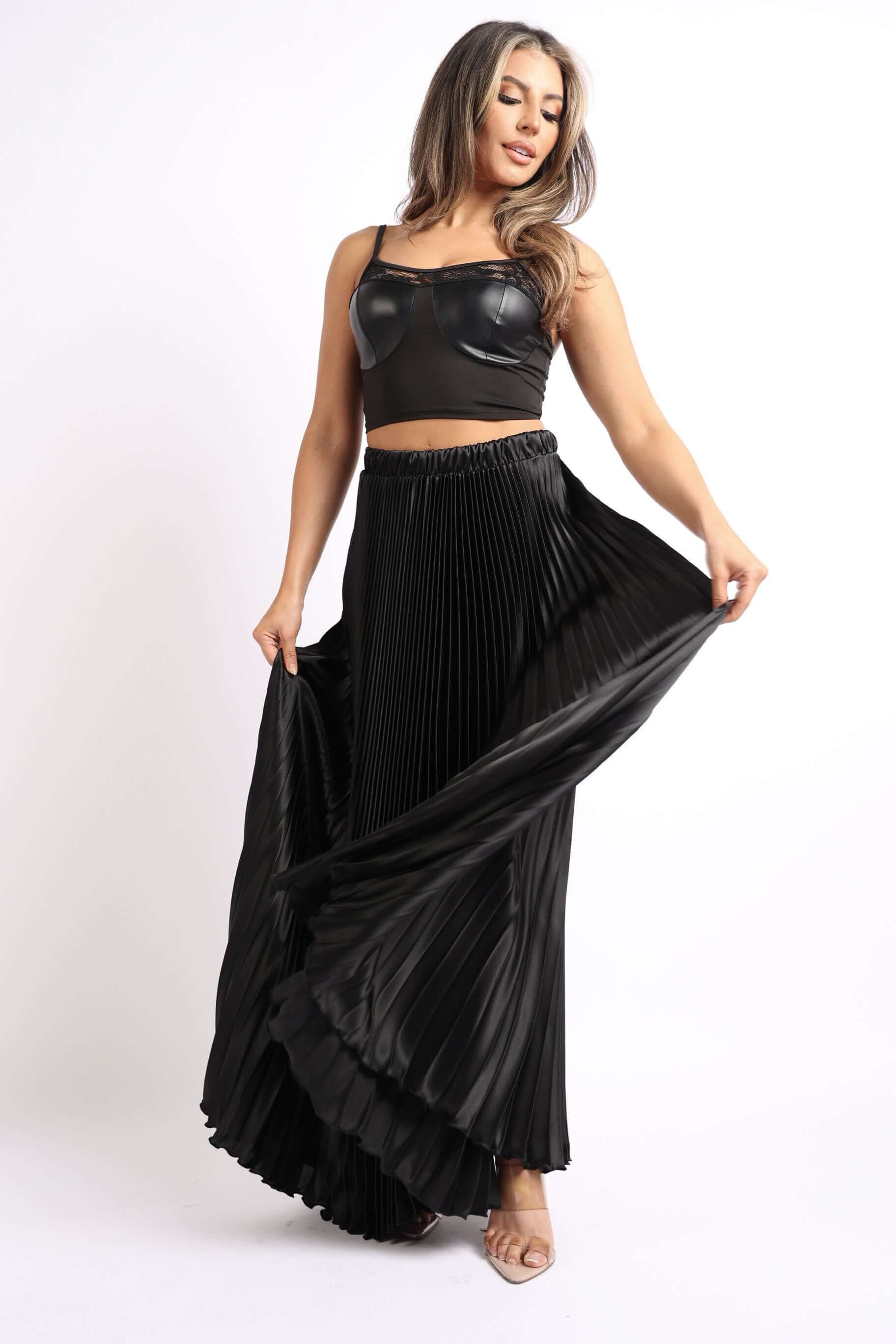 Elastic High Waist A-Line Pleated Satin Maxi Skirt Formal Prom BLACK modeled by a woman in a stylish top and flowing skirt.