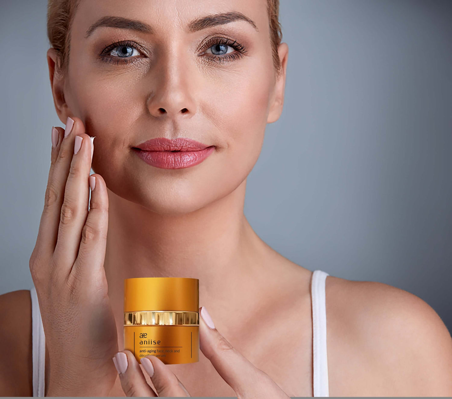 Aniise anti-aging face neck and décolleté serum in a golden container for rejuvenation and hydration.