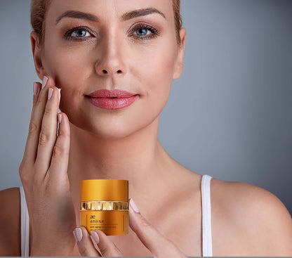 Aniise anti-aging face neck and décolleté serum in a golden container for rejuvenation and hydration.